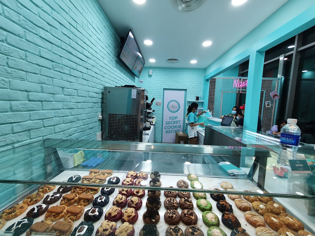 A vibrant interior shot of Nasty Cookie, showcasing a wide array of gourmet cookies in a display case.