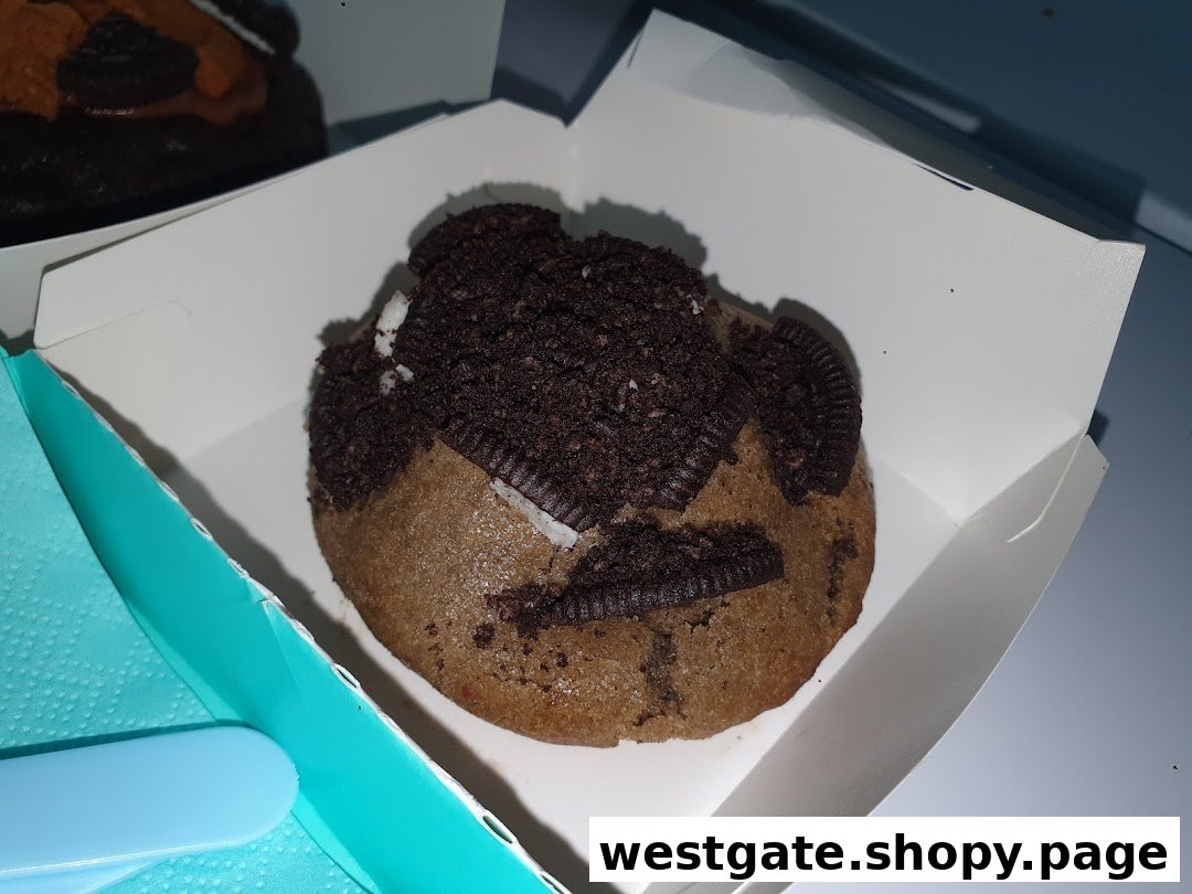 A delicious Nasty Cookie topped with Oreo crumbs and pieces in a white box.
