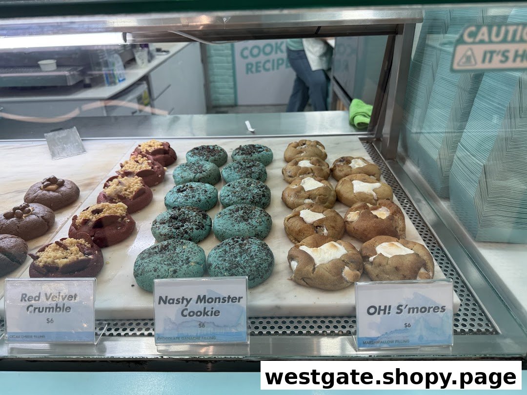 A vibrant display of gourmet cookies, including Red Velvet Crumble, Nasty Monster, and OH! S'mores.