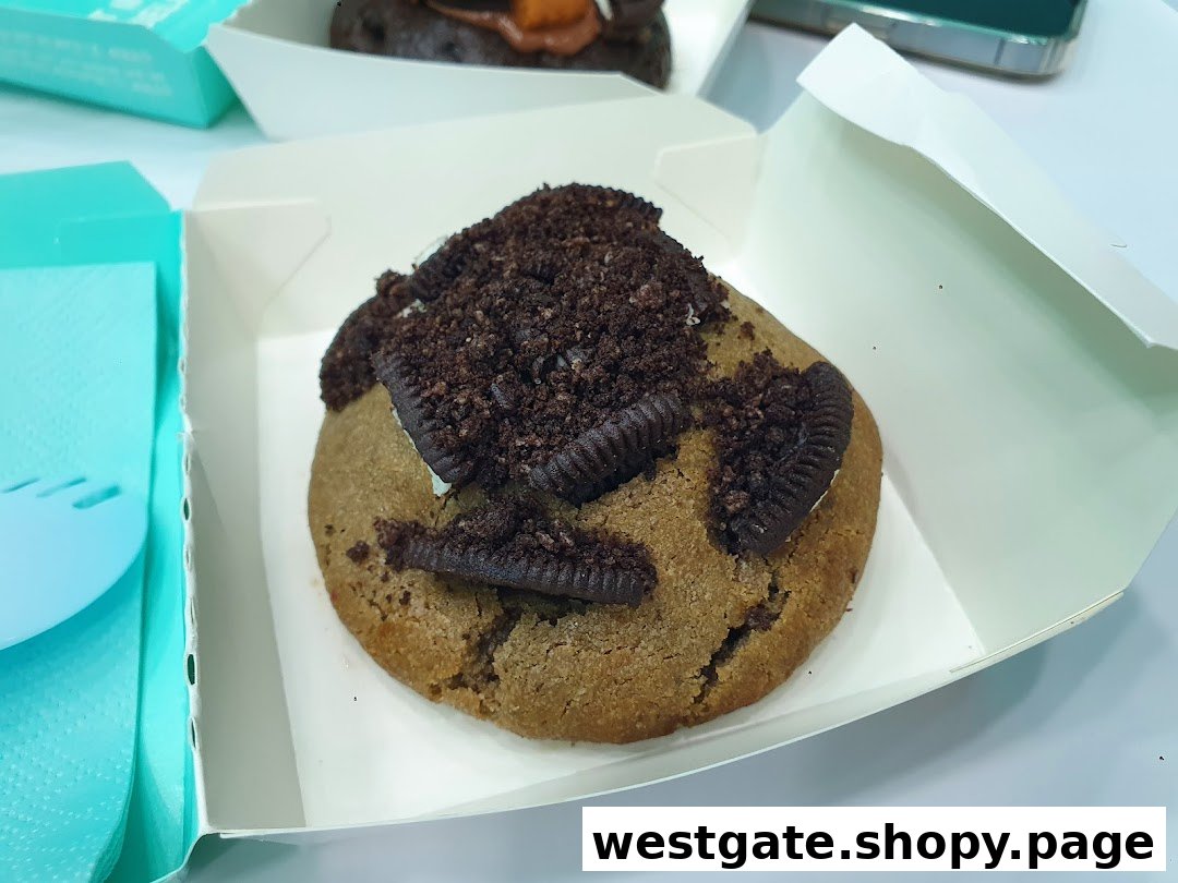 A delicious Nasty Cookie with Oreo pieces and crumbs in a white box.