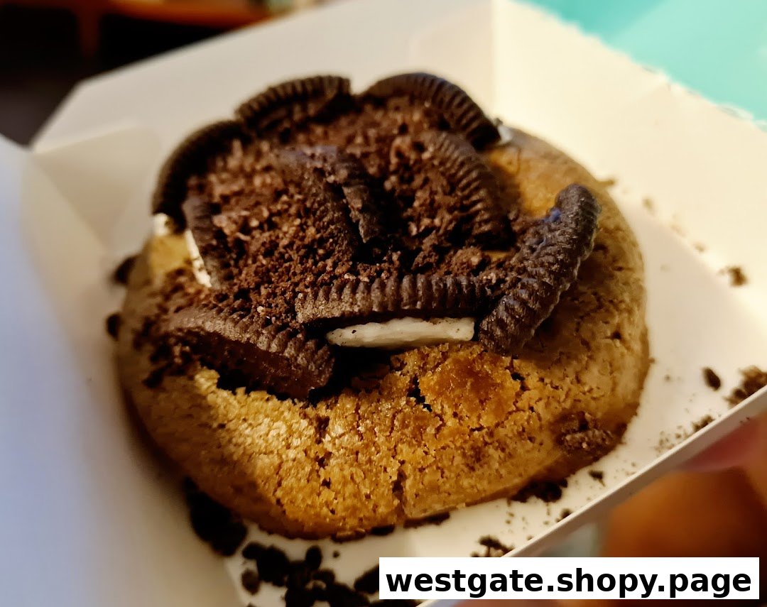A close-up of a delicious Nasty Cookie topped with crushed Oreos and cookie pieces.