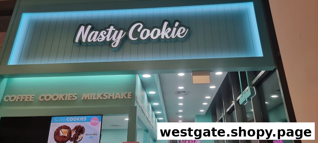 The vibrant teal exterior and illuminated sign of Nasty Cookie, featuring their coffee, cookies, and milkshake offerings.