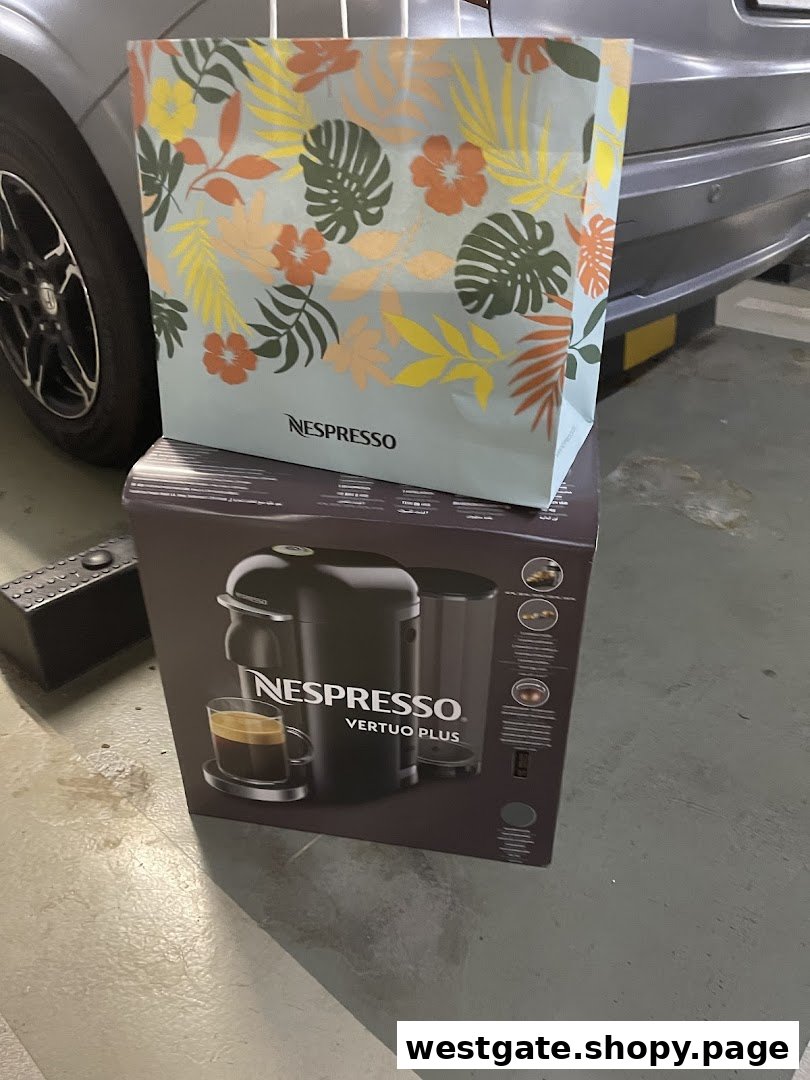 A Nespresso Vertuo Plus machine box topped with a tropical-themed Nespresso shopping bag.