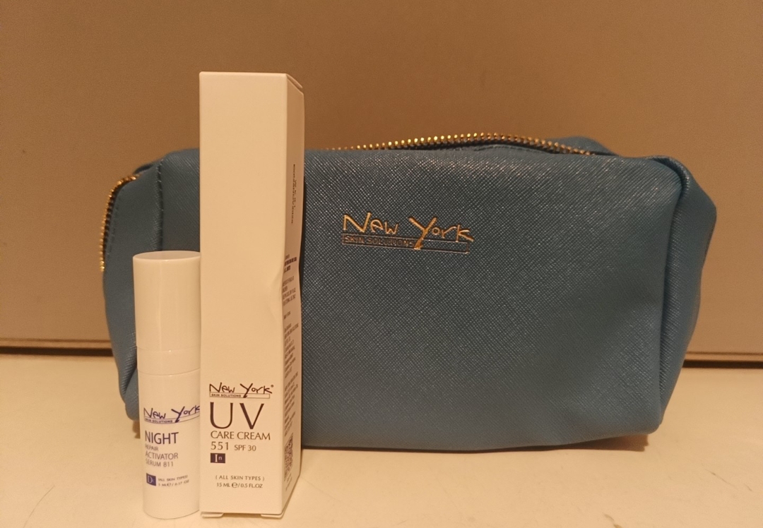 New York Skin Solutions skincare products, including UV cream, night serum, and a branded cosmetic bag.