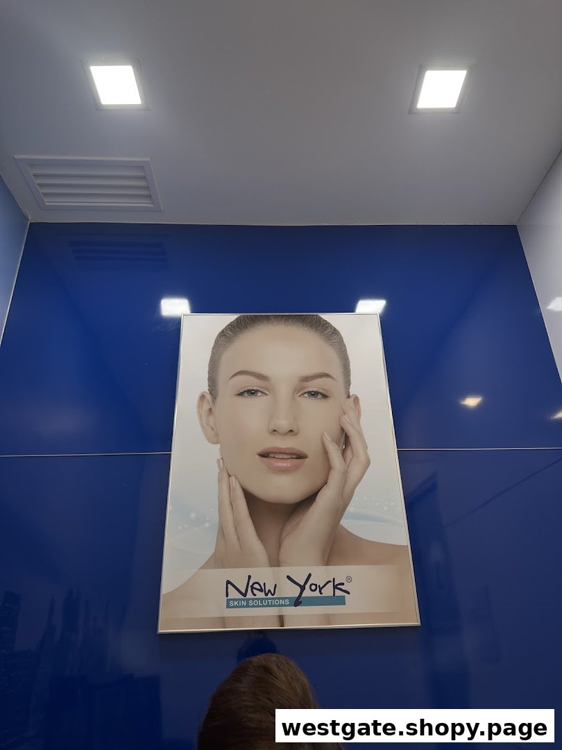 A large poster featuring a woman's face on a vibrant blue wall inside New York Skin Solutions.