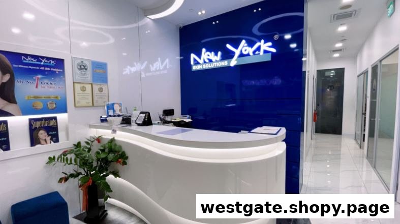 The bright and modern reception area of New York Skin Solutions, featuring a white desk and blue branding.