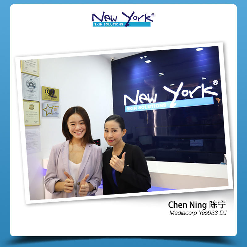 Two smiling women giving thumbs up inside New York Skin Solutions, with awards visible.