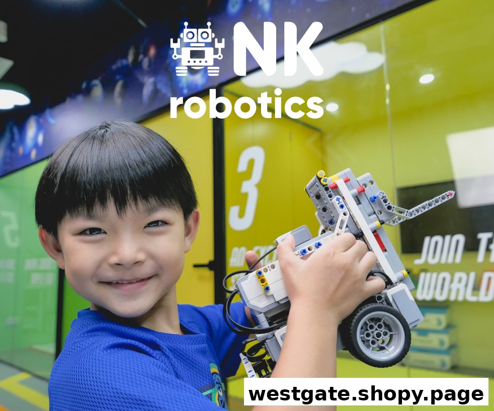 A smiling child holds a robot, showcasing the engaging learning experience at NK Robotics.
