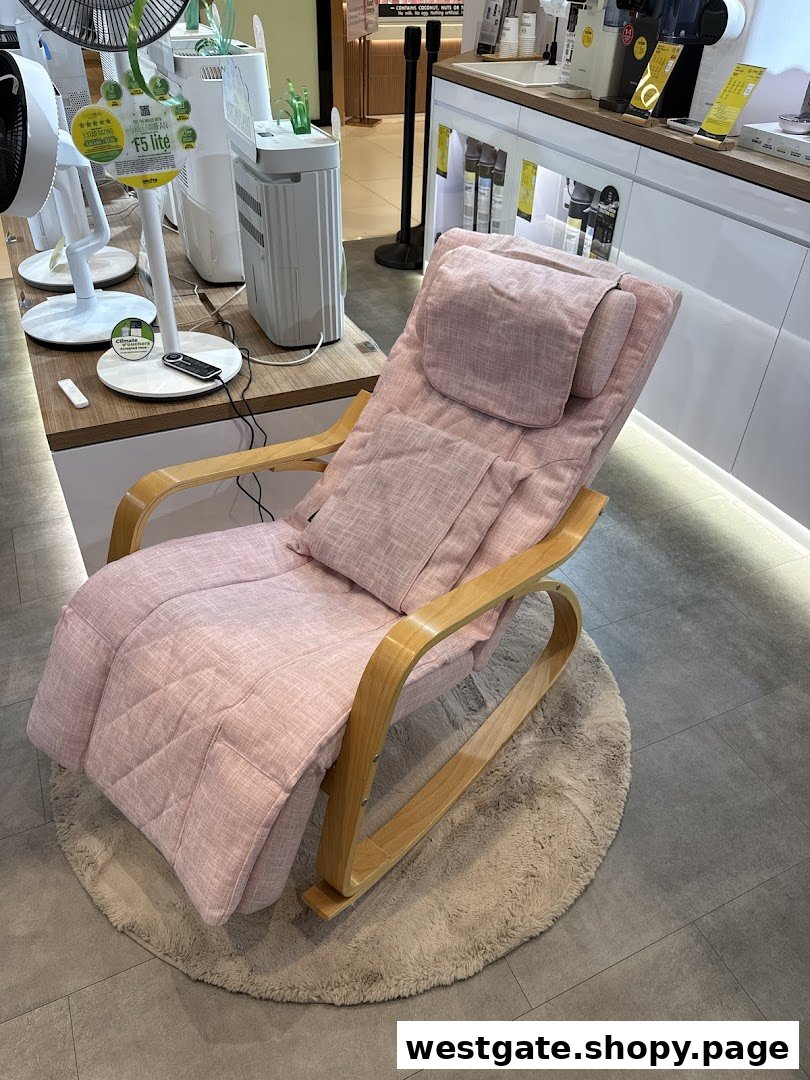 A comfortable pink massage chair on a round rug, displayed in a retail setting with other home appliances.