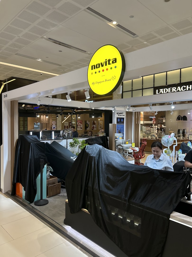 The Novita shop entrance at Westgate, featuring its distinctive yellow circular logo and covered displays.