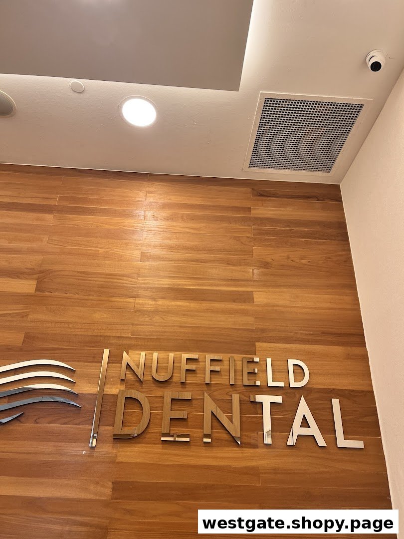 The image shows the Nuffield Dental logo and name on a modern wooden wall.