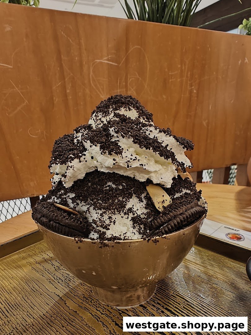 A large bowl of cookies and cream bingsu, a Korean shaved ice dessert, topped with whipped cream.