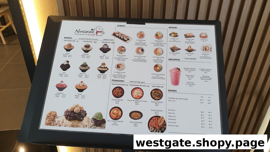 A digital menu board displaying various Korean desserts, gimbap, tteokbokki, smoothies, and drinks.