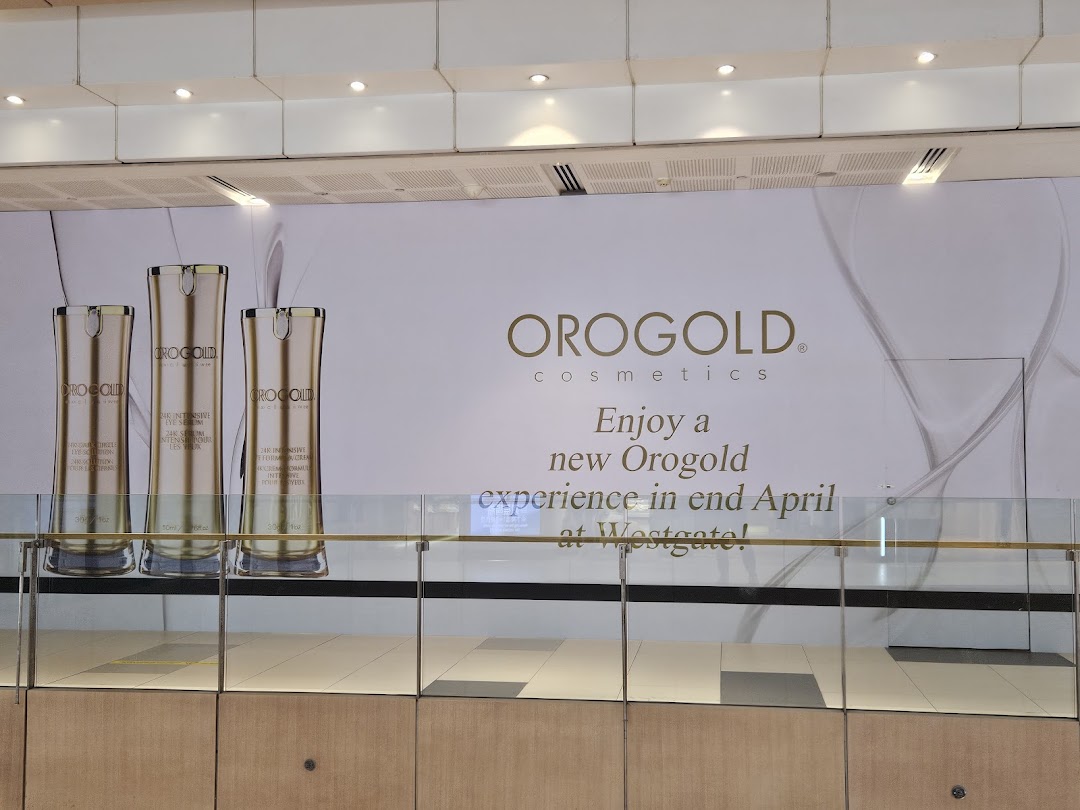 A large OROGOLD Cosmetics banner featuring product bottles and an announcement for a new experience.
