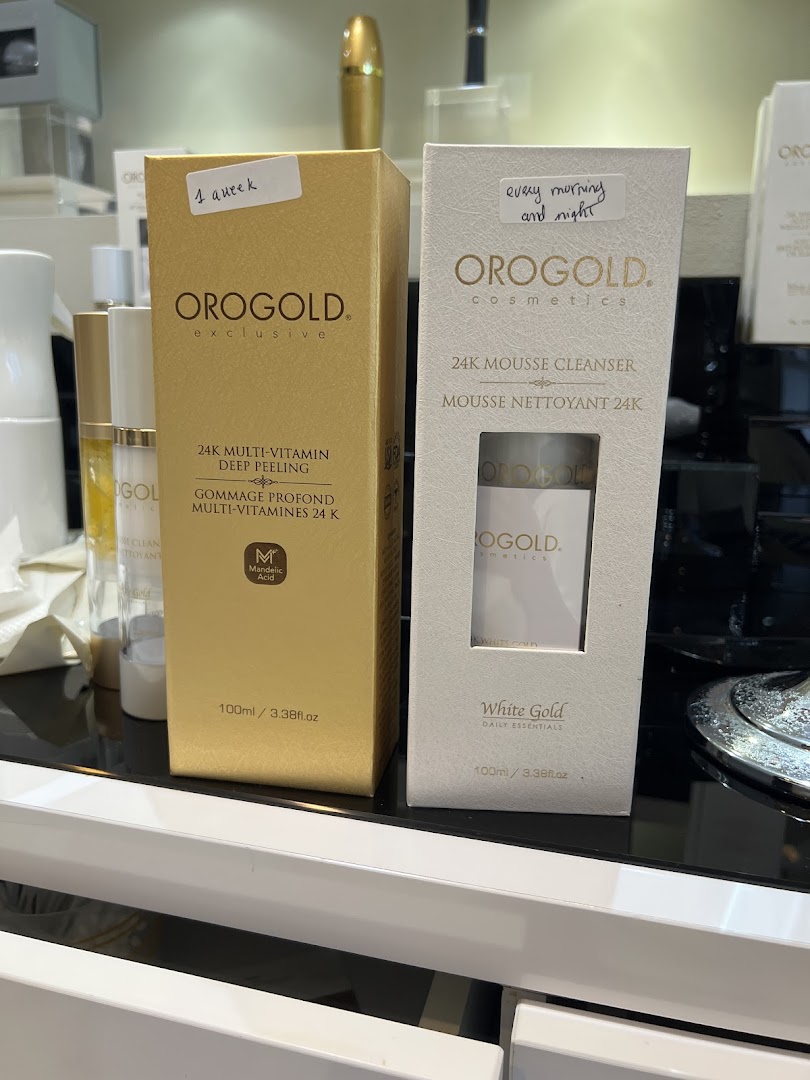 Two OROGOLD cosmetic product boxes, a deep peeling and a mousse cleanser, are displayed.