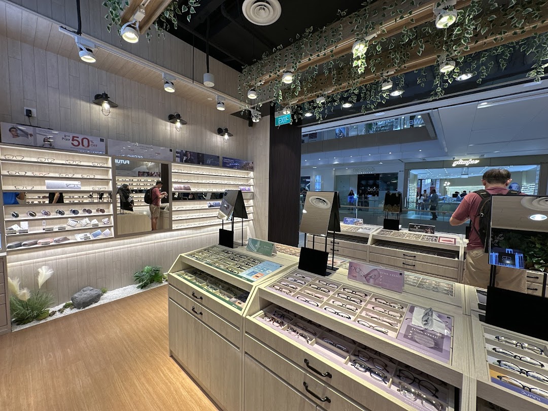 Interior view of OWNDAYS Westgate, showcasing a wide selection of stylish eyewear and a customer browsing.