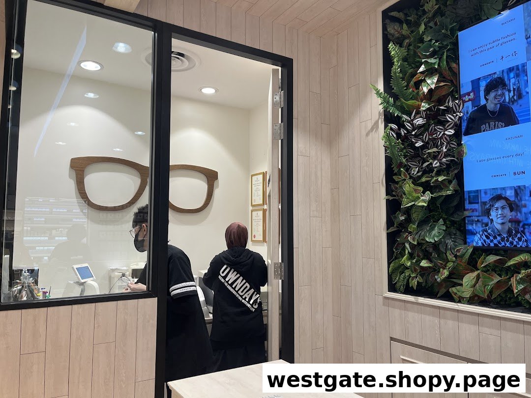 Interior view of OWNDAYS Westgate, showing staff, a large glasses display, and a digital screen with customer testimonials.