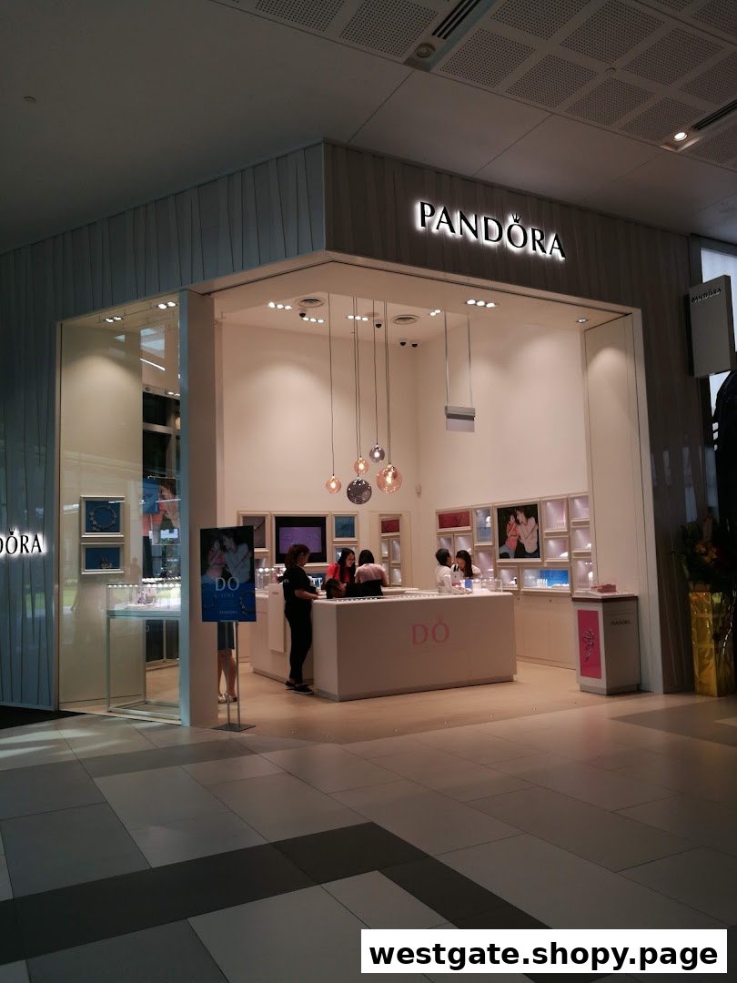 The brightly lit entrance of a Pandora jewelry store, showcasing its inviting interior and displays.