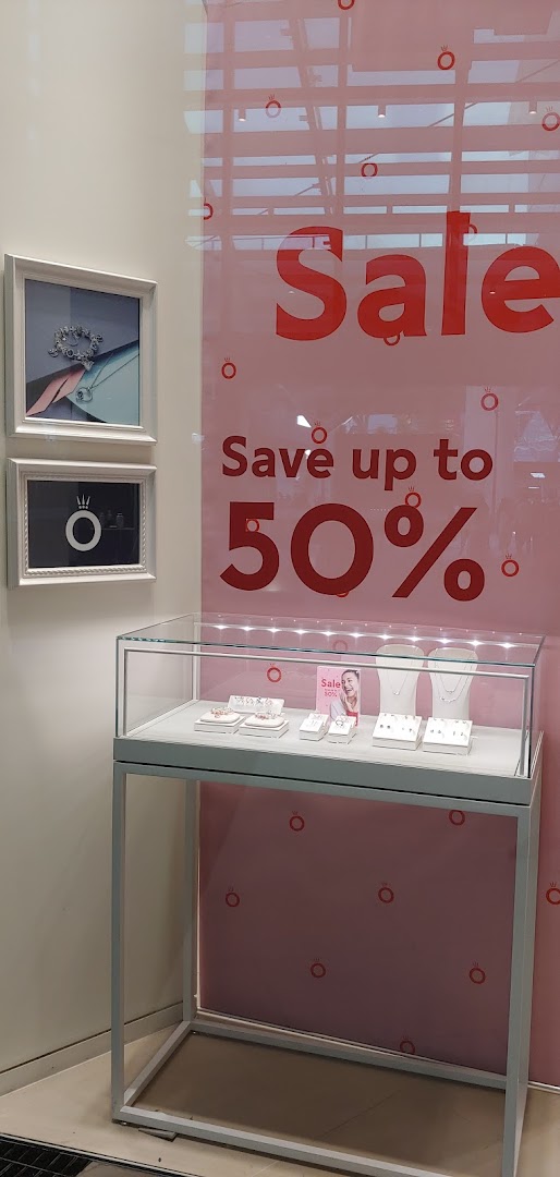 Pandora shop window display featuring a 'Sale Save up to 50%' sign and jewelry showcases.