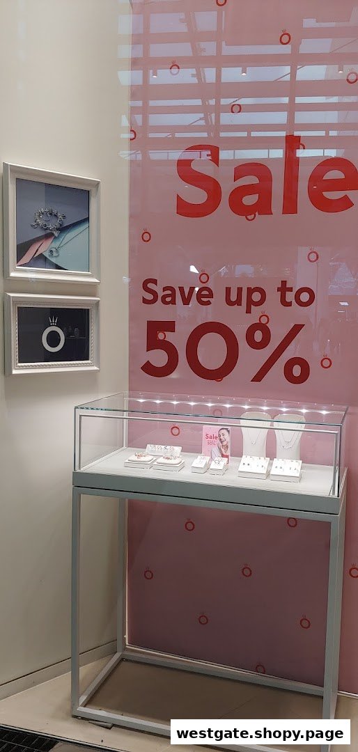 Pandora shop window display featuring a 'Sale Save up to 50%' sign and jewelry showcases.