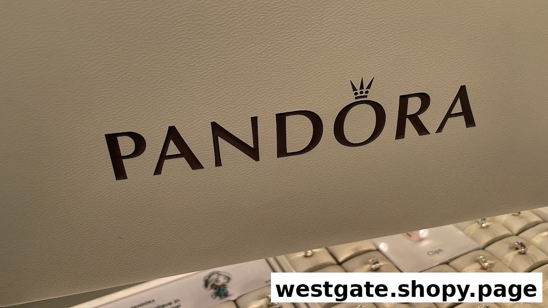 Close-up of the Pandora logo above a display case filled with various jewelry pieces.