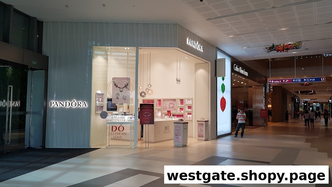 The brightly lit entrance of a Pandora jewelry store showcasing elegant displays and signage.