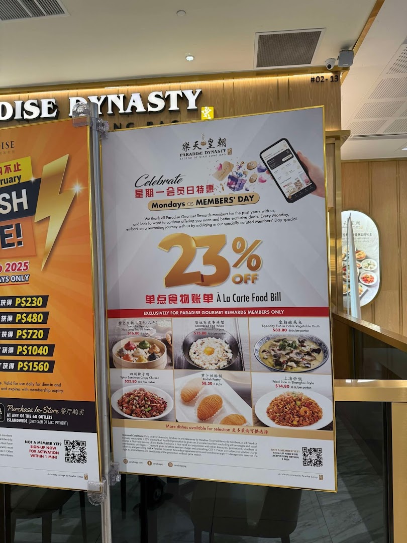 A promotional display board for Paradise Dynasty, highlighting Members' Day discounts and featured dishes.