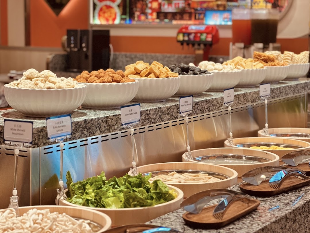 A vibrant hotpot buffet bar showcasing a wide array of fresh ingredients for a customizable dining experience.