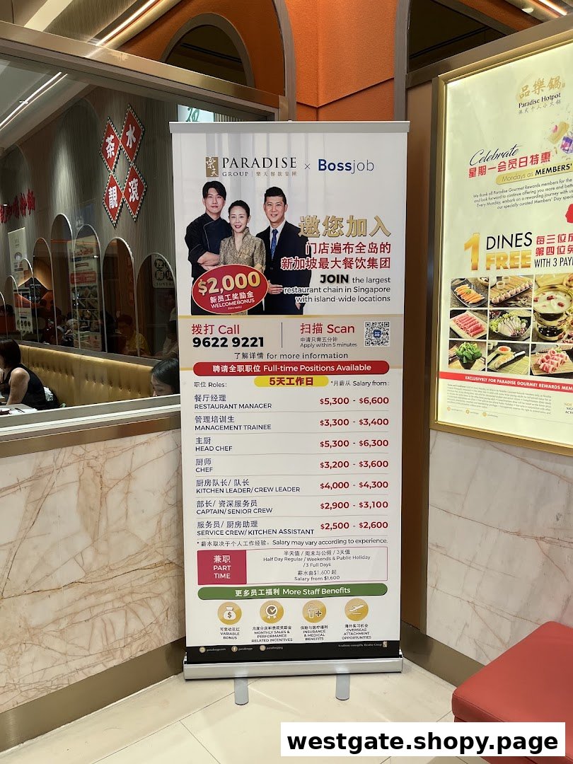 An interior shot of Paradise Hotpot featuring a recruitment banner for Paradise Group and a promotional poster.