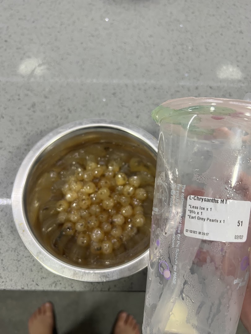 A close-up of PlayMade's fresh Earl Grey pearls in a bowl next to a customized bubble tea cup.