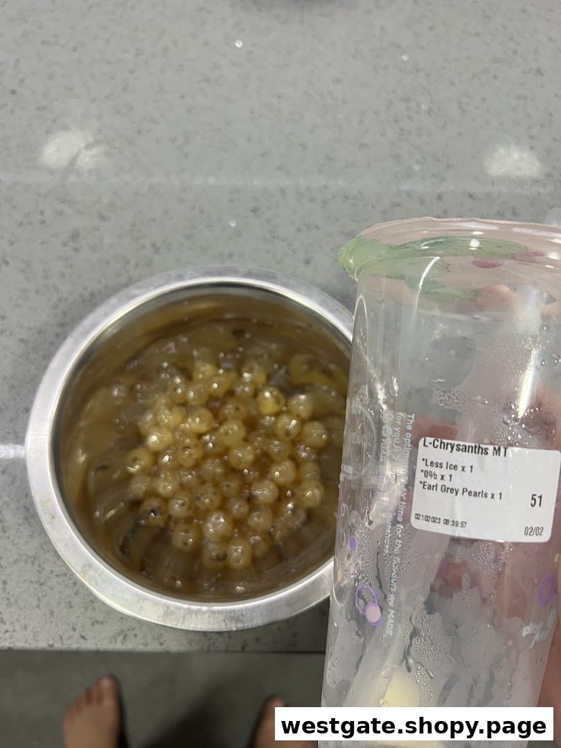 A close-up of PlayMade's fresh Earl Grey pearls in a bowl next to a customized bubble tea cup.