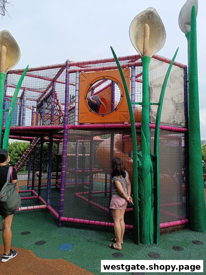 A vibrant outdoor playground with a large climbing structure and two adults observing.