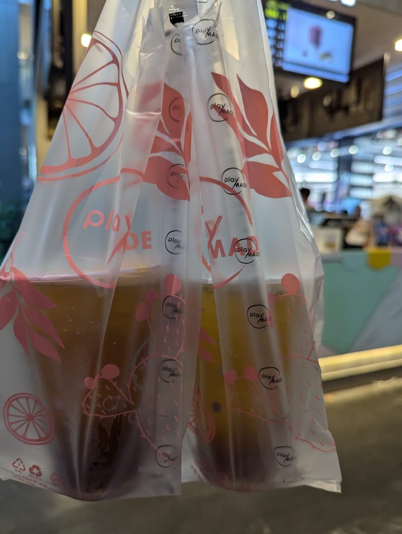 Two PlayMade bubble tea drinks in a branded plastic carrier bag.