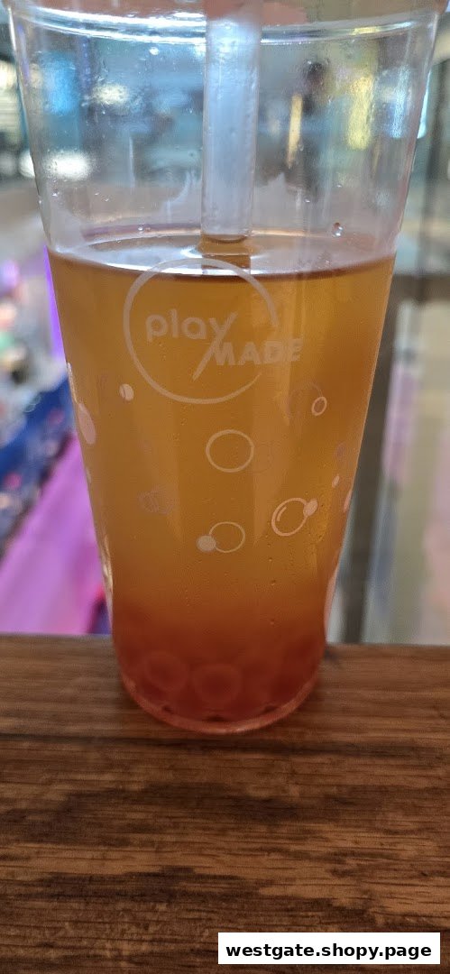 A close-up of a refreshing PlayMade bubble tea with colorful boba pearls.