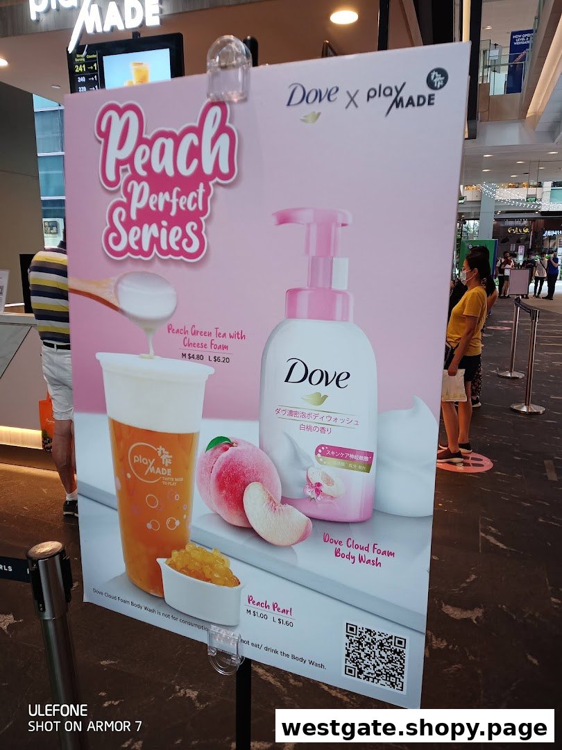 A promotional standee for PlayMade's Peach Perfect Series, featuring a collaboration with Dove.
