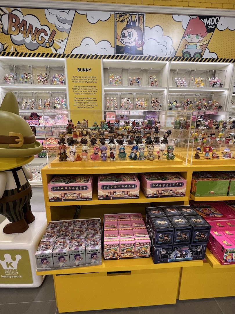 Interior view of POP MART, showcasing shelves filled with colorful collectible art toys and blind boxes.