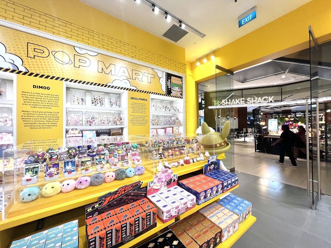 Interior view of POP MART showcasing colorful collectible toys, blind boxes, and character displays.