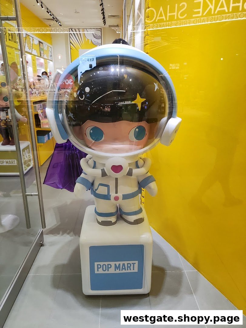 A large astronaut-themed figure stands at the entrance of POP MART, inviting visitors into the vibrant store.