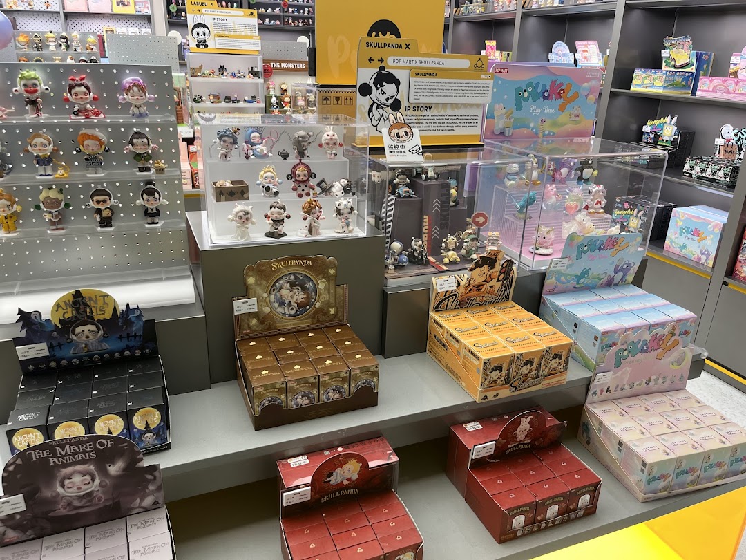An interior view of POP MART, showcasing various collectible art toys and blind boxes on display shelves.