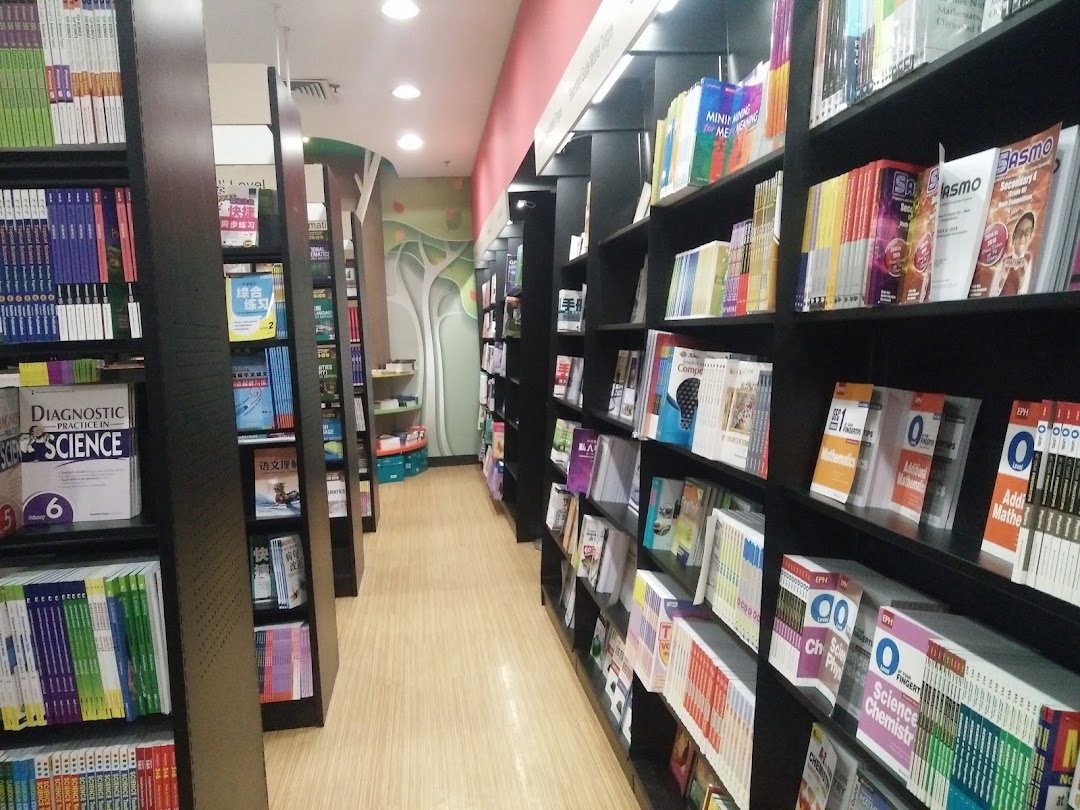 A well-lit aisle inside a bookstore, lined with shelves of various books and educational materials.
