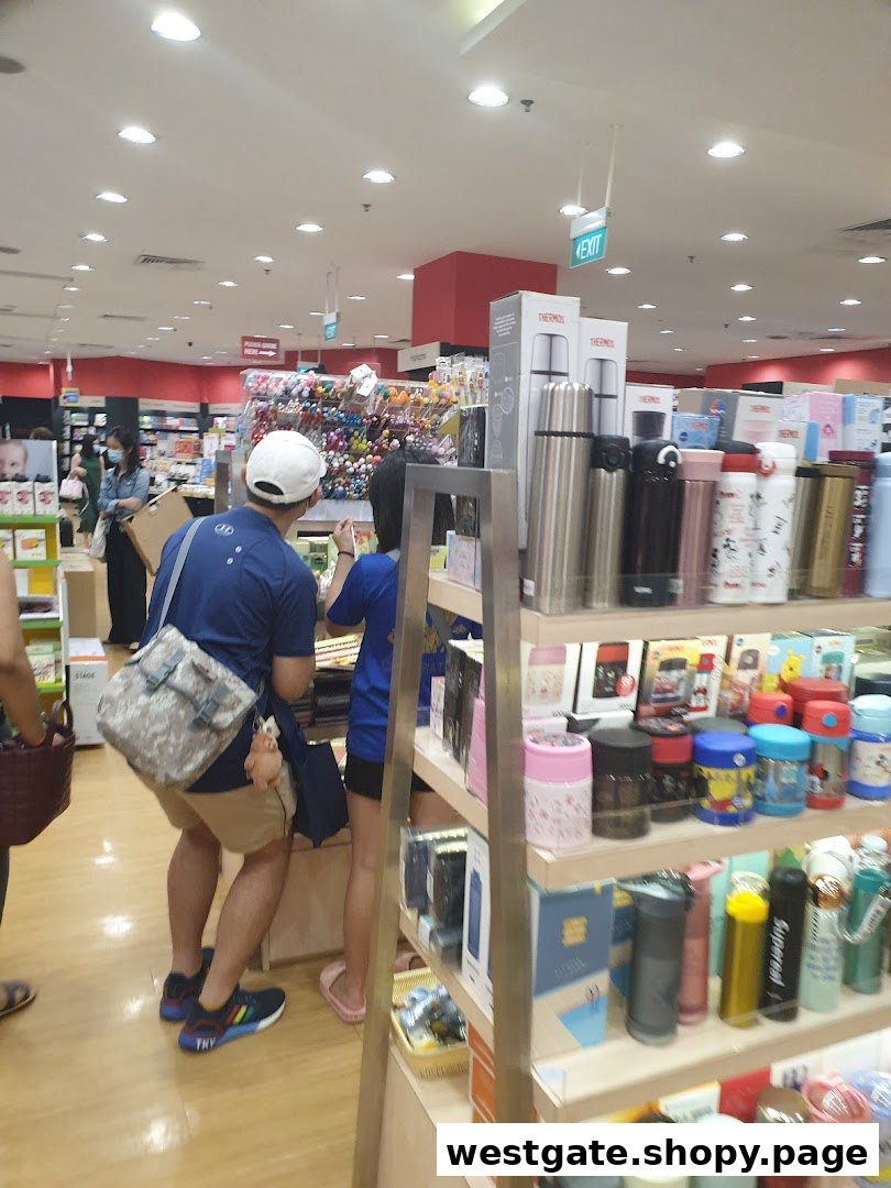 Customers browse various products, including stationery and drinkware, inside a bustling bookstore.
