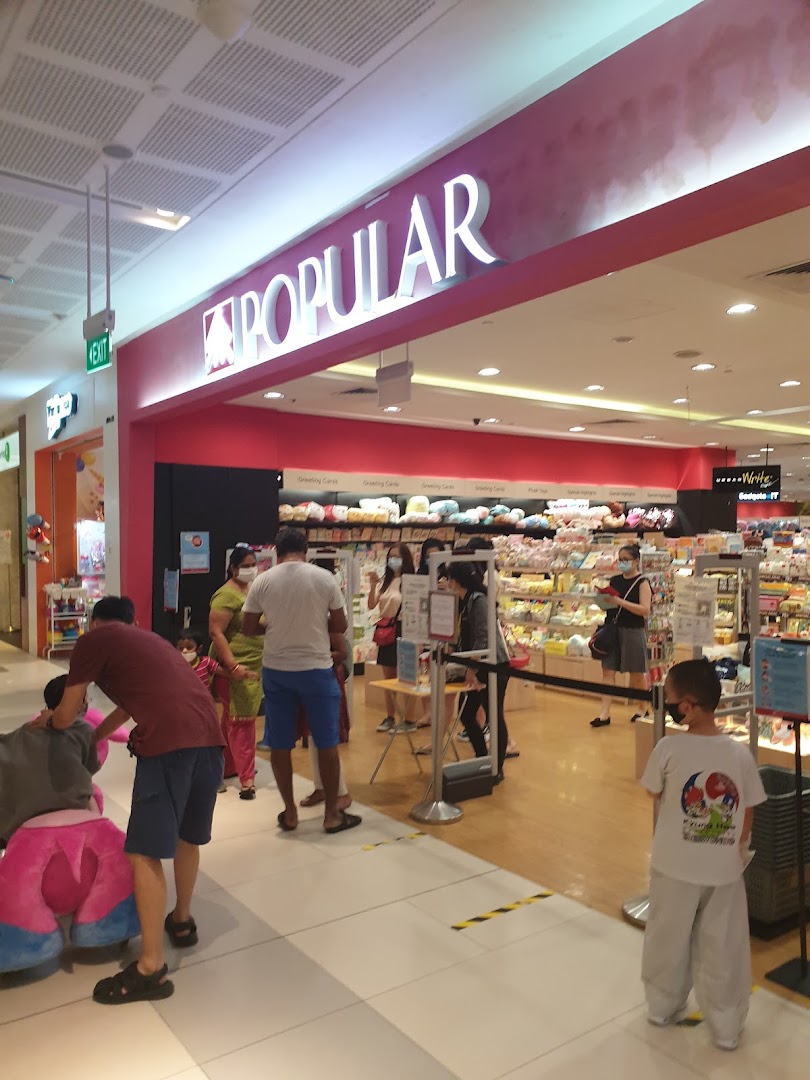 The entrance of POPULAR Bookstore with its prominent signage and customers inside.