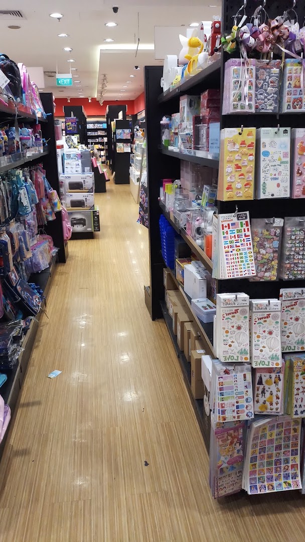 An aisle inside POPULAR Bookstore, showcasing shelves filled with stationery, bags, and various products.