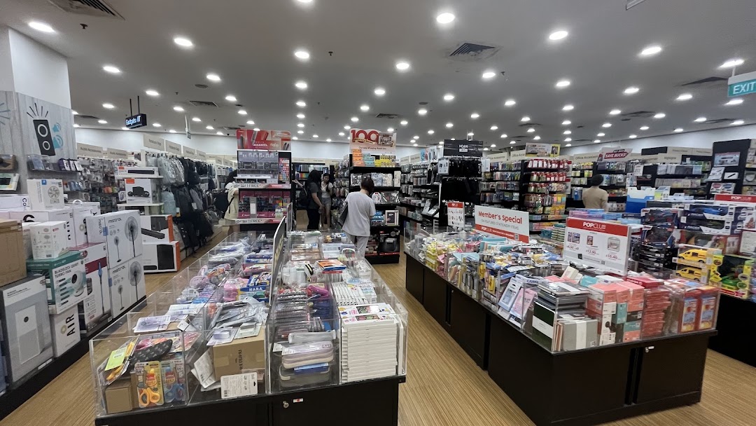 An interior view of POPULAR Bookstore, showcasing various stationery, gadgets, and books with customers browsing.