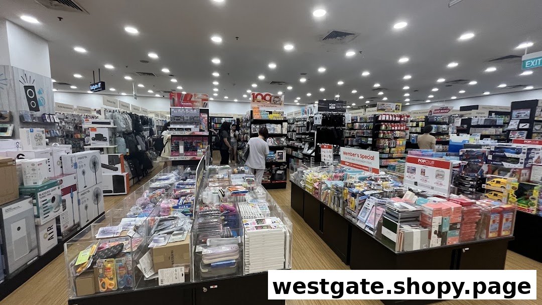 An interior view of POPULAR Bookstore, showcasing various stationery, gadgets, and books with customers browsing.