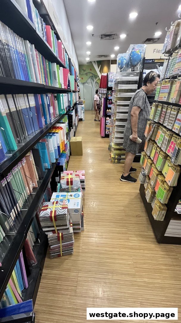 Interior view of POPULAR Bookstore, showing shelves filled with stationery and a customer browsing.