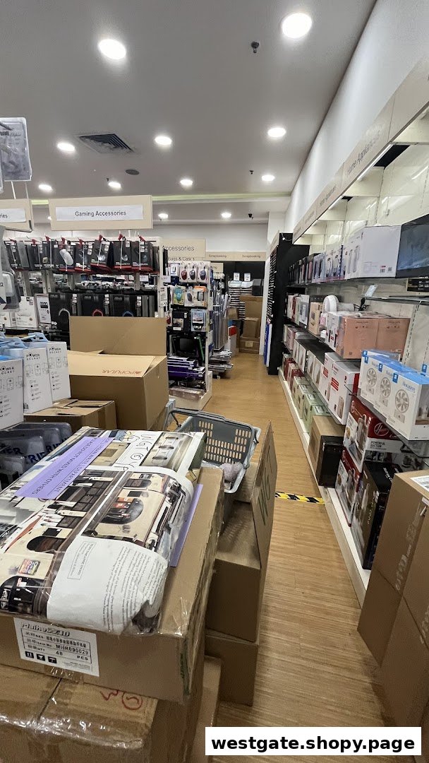 An interior view of a retail store aisle with shelves displaying products and stacked boxes.