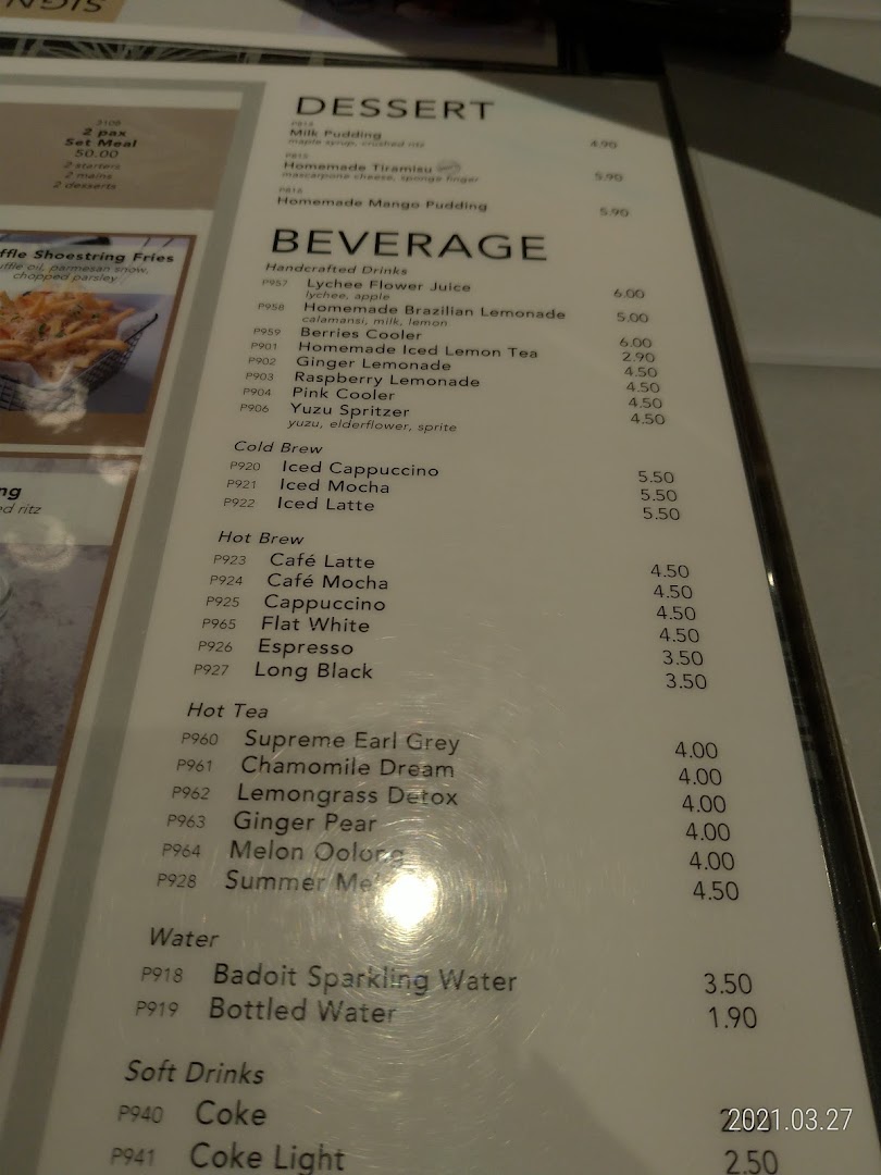 A close-up view of a menu page from Poulet, featuring desserts, handcrafted beverages, coffees, teas, and soft drinks.