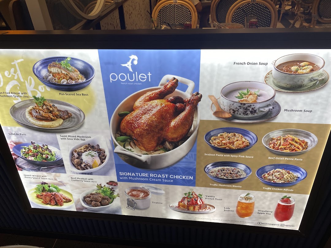A brightly lit display menu showcasing various French-inspired dishes and drinks from Poulet restaurant.
