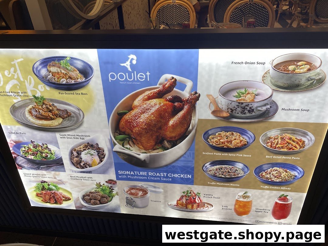 A brightly lit display menu showcasing various French-inspired dishes and drinks from Poulet restaurant.